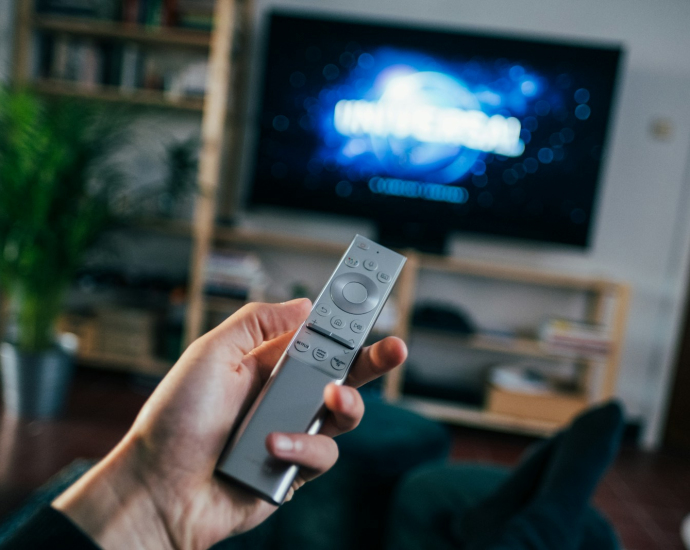 person holding gray remote control