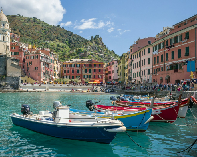 white and blue boat on water near buildings during daytime