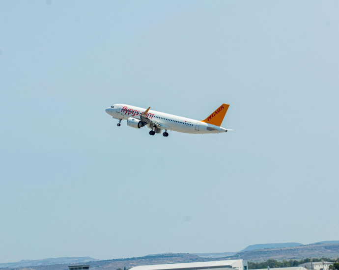 a large jetliner flying through a blue sky