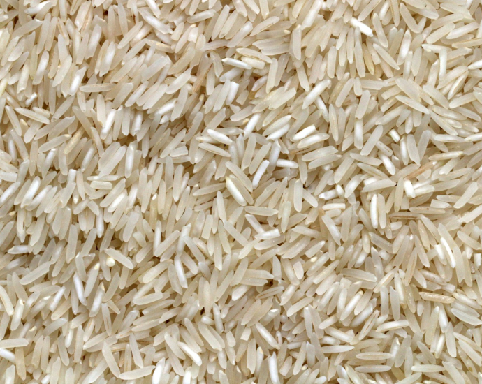 white rice grains on brown wooden table