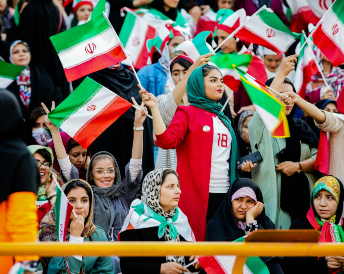 crowd of people holding mini flags