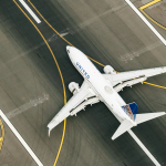 white and blue airplane on airport during daytime