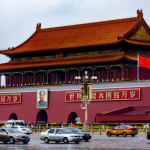 cars parked in front of red and brown building